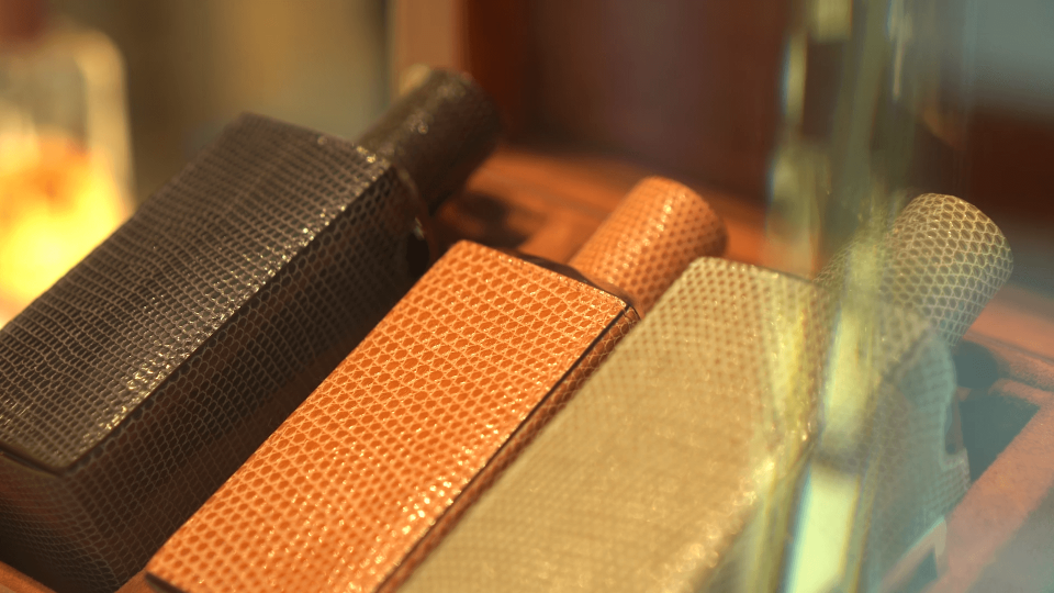 Perfume bottles in prestigious leather cases.