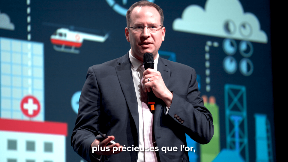 Presenter with a microphone talking to attendees