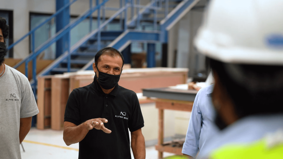 Man brieffing his team in a warehouse.